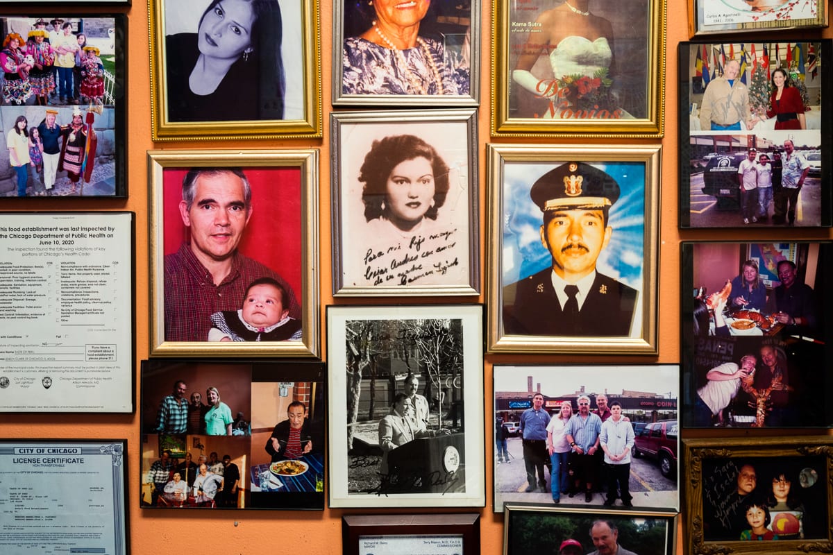 A wall inside Taste of Peru in Chicago Ill.’s Rogers Park neighborhood is decorated with an array of family portraits, with a spot of honor reserved for an image commemorating Guy Fieri’s visit to the restaurant. Photo by Camilla Forte/Borderless Magazine