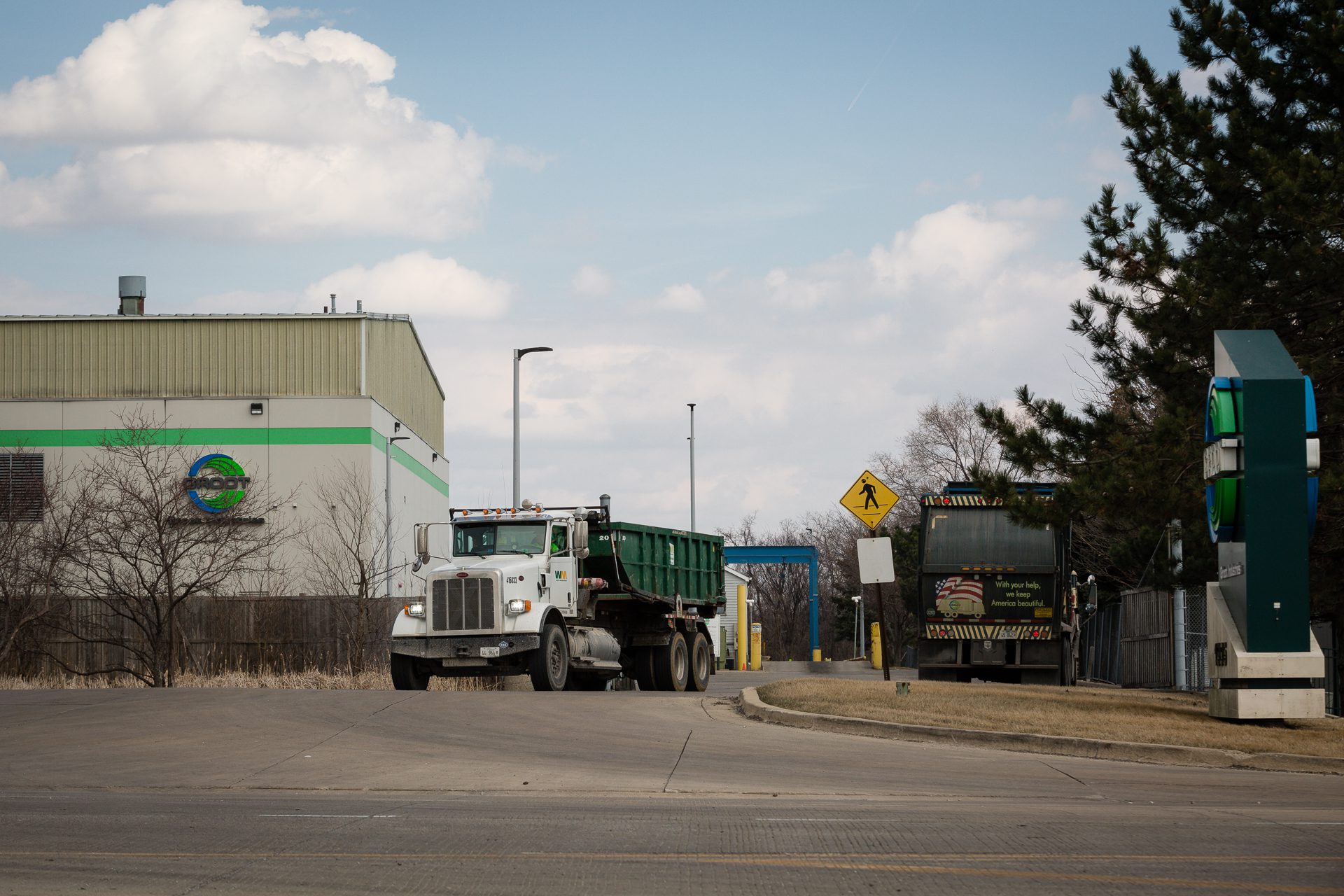 A Groot garbage trucks pulls out of the waste transfer facility as another pulls in