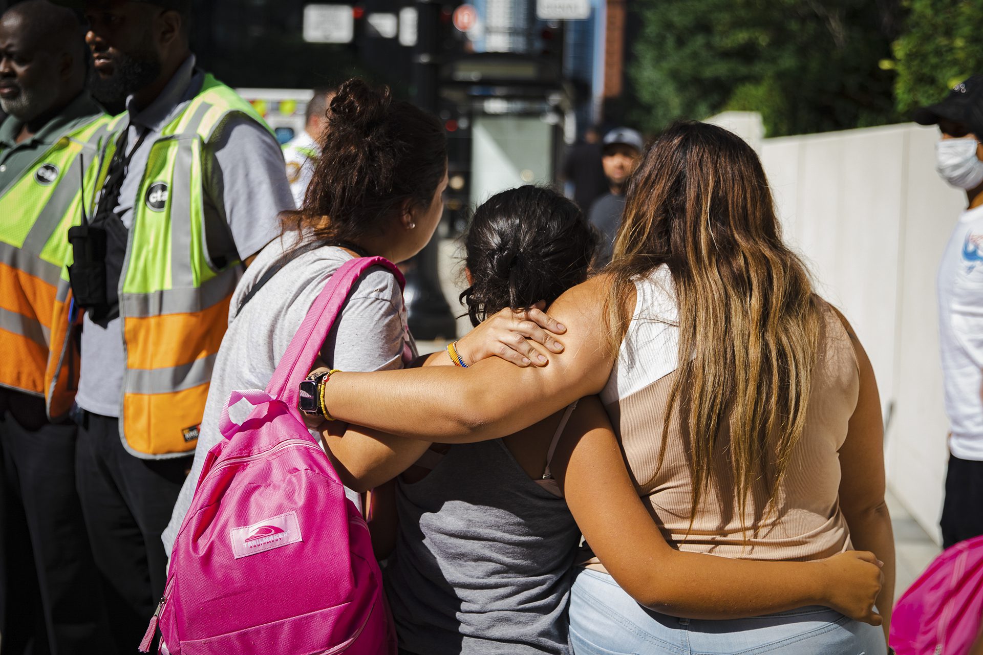 Migrants hub by a bus after being sent to Chicago from Texas by Gov. Greg Abbott