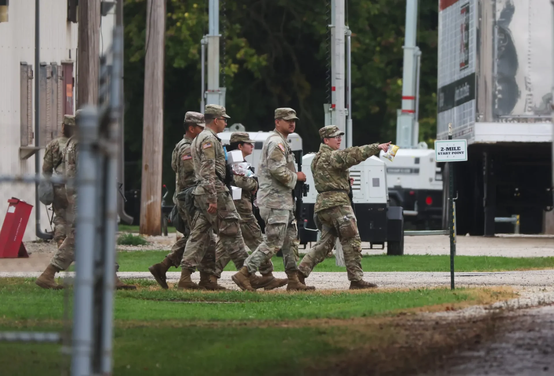 A group of Texas National Guard soldiers in uniform walk around at the Joliet Local Training Area in suburban Elwood, Illinois