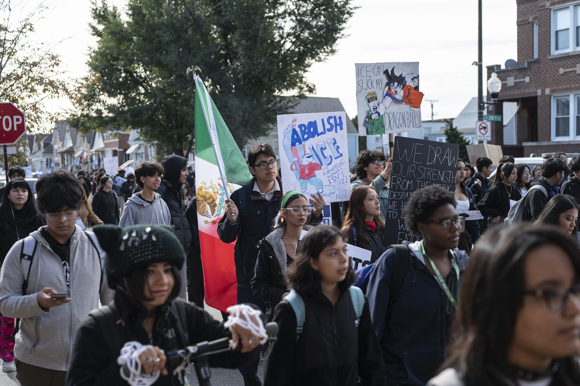A large crowd of students from Little Village Lawndale High School, some carrying signs, march towards 26th Street during a walkout in protest of recent immigrant enforcement across Chicago on Oct. 28, 2025.