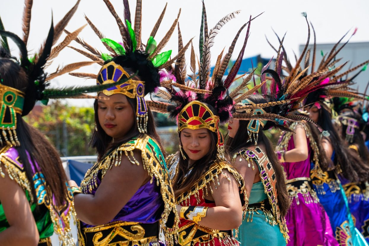 A group Aztec dancers wearing Aztec headdresses lead a procession opening the People's Mass during Fiesta del Sol on Sunday, Aug 3, 2025.