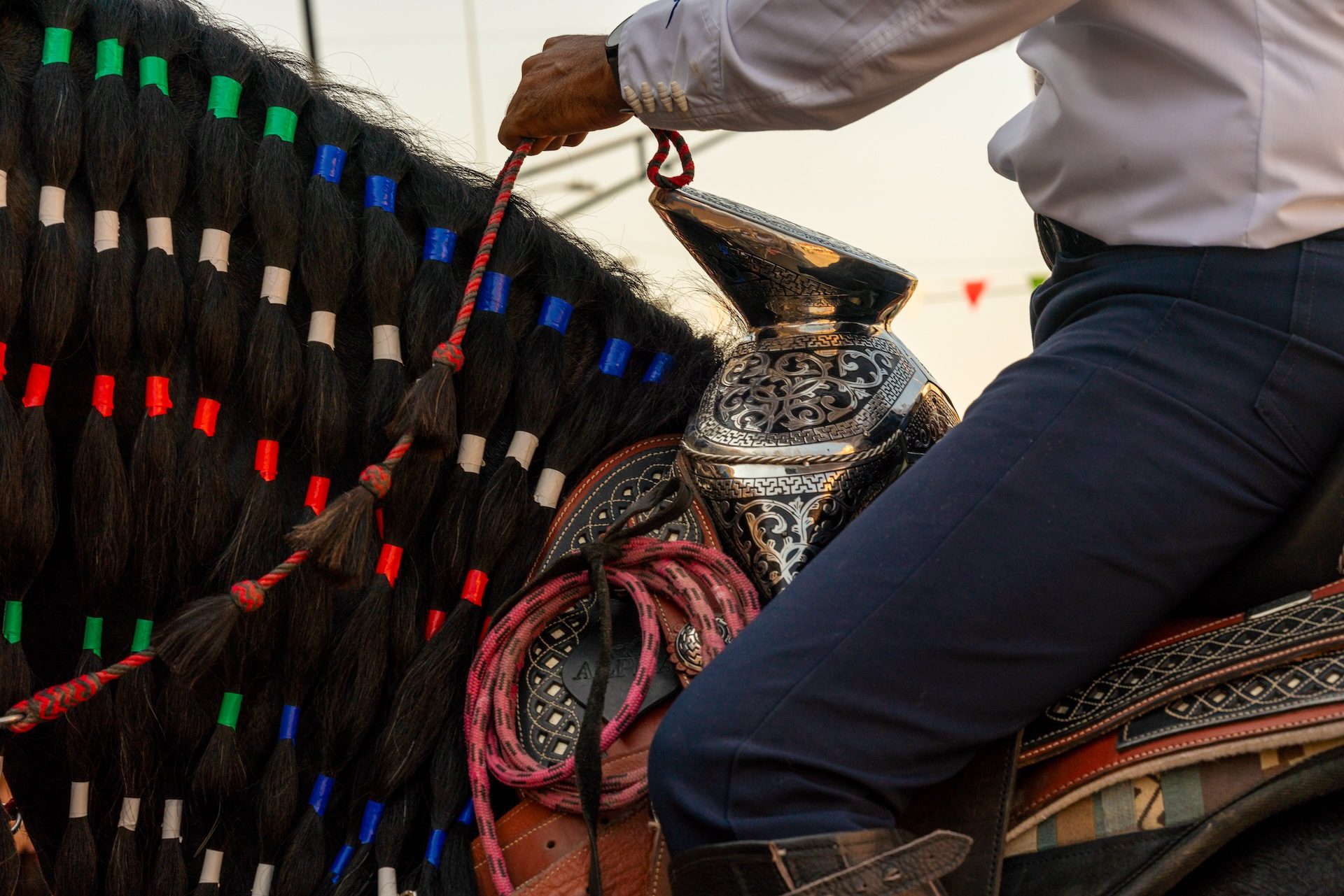 A close-up view of a horse saddle and braids in a hair's mane are seen as riders with Urban Warriors participate in the Little Village Mexican Independence Day parade on Sunday, Sept. 15, 2025.