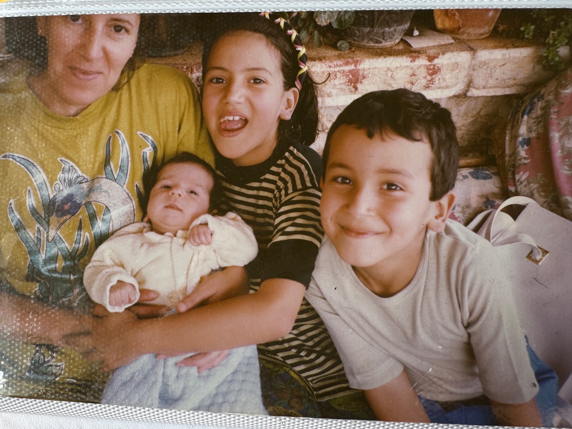 An archival photo shows Toufic with his mom and sisters when his younger sister, Zahwa, was born in the early 1990s.
