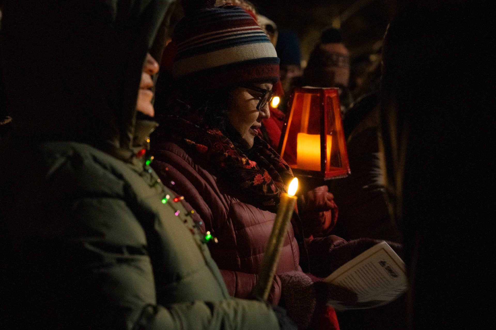 Ismelda Salazar, organizer with South West Organizing Project (SWOP), is seen outside at night as she sings for lodging during a posada reenactment in Oak Park on Dec. 19, 2025.