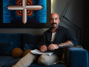 Lebanese interior architect Toufic Alayyash, seen with his sketch book on his lap, sits inside his home office on Nov. 10, 2025.