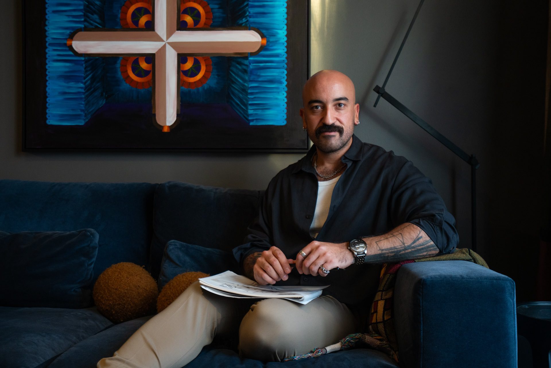 Lebanese interior architect Toufic Alayyash, seen with his sketch book on his lap, sits inside his home office on Nov. 10, 2025.