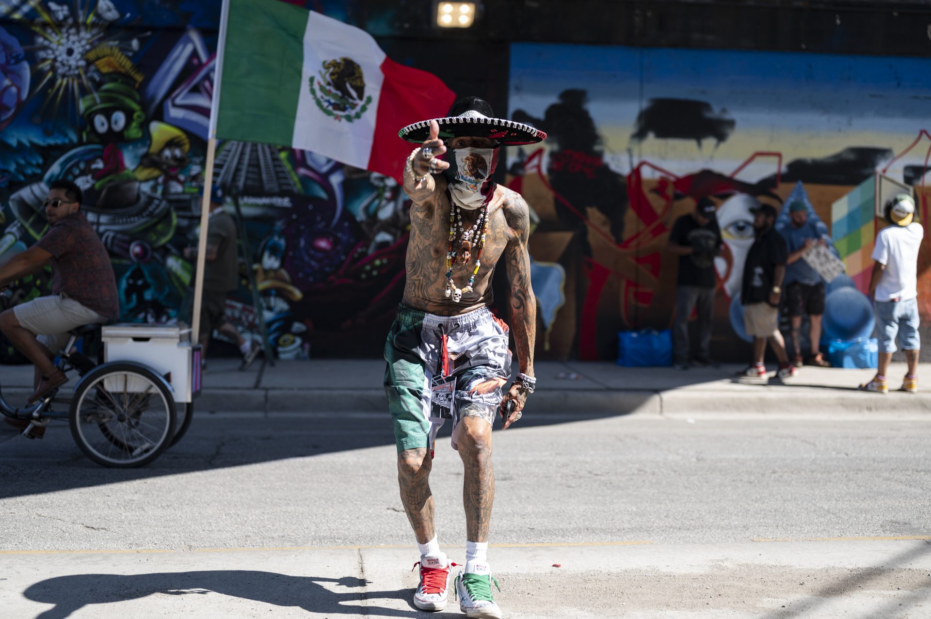 Edward Zavala, wearing a sombrero and bandana with the Mexican flag, poses as the South Chicago Mexican Independence Day Parade passes by the Meeting of Styles graffiti festival on Commercial Avenue, Sunday, Sept. 14, 2025.