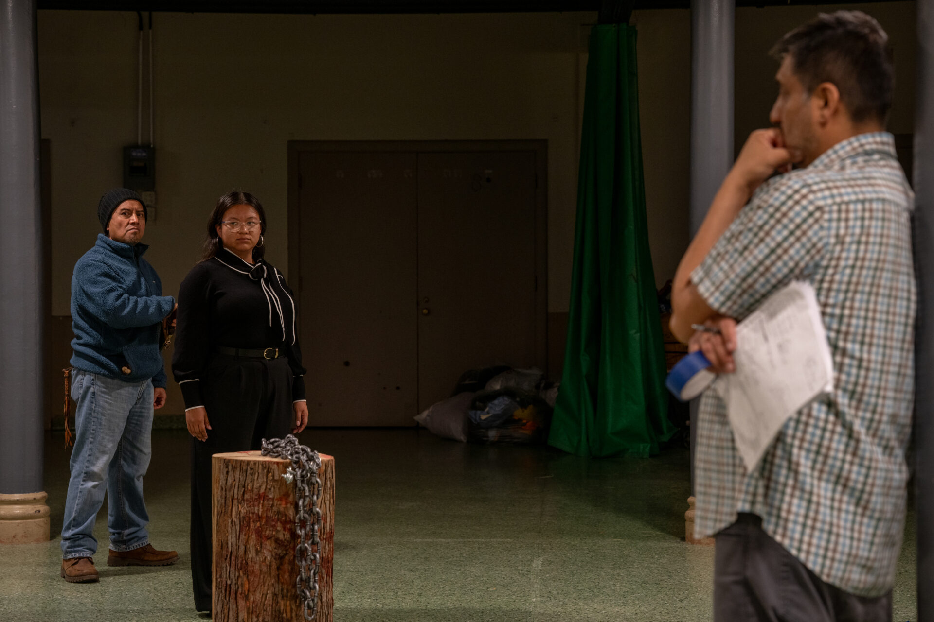 Zitlalic Castillo rehearses for the Via Crucis procession as director Isaac Barrera, standing across the room, looks on.