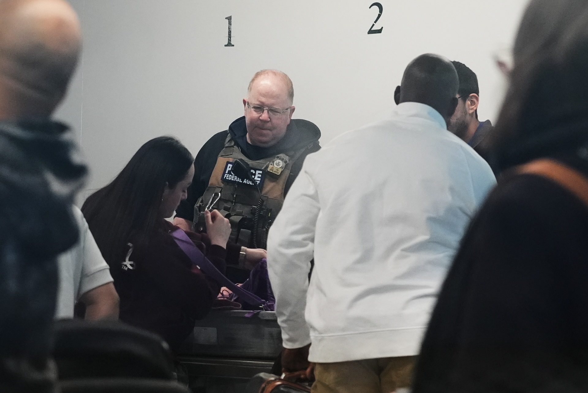 A federal agent at the baggage check at O'Hare airport.