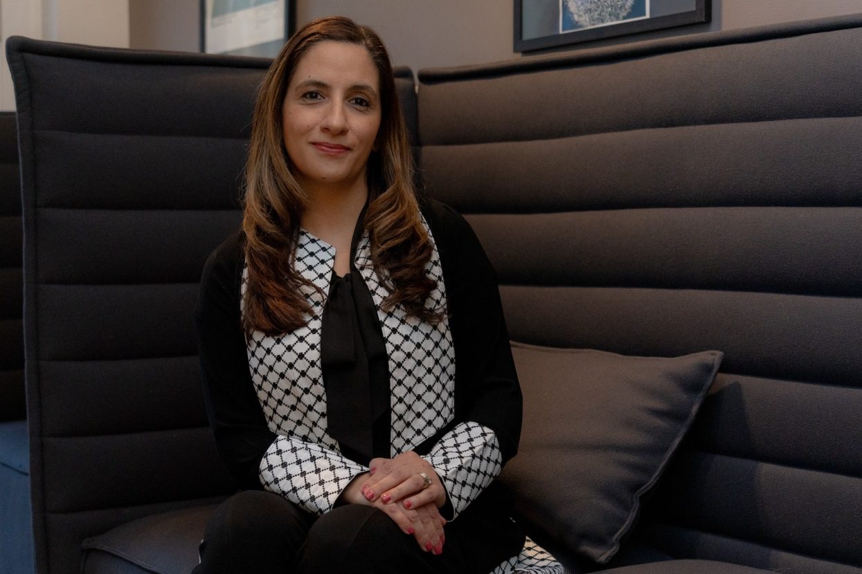 Nina Shoman-Dajani, Executive Director of the Chicago Palestine Film Festival, sits on a couch inside the Gene Siskel Film Center.