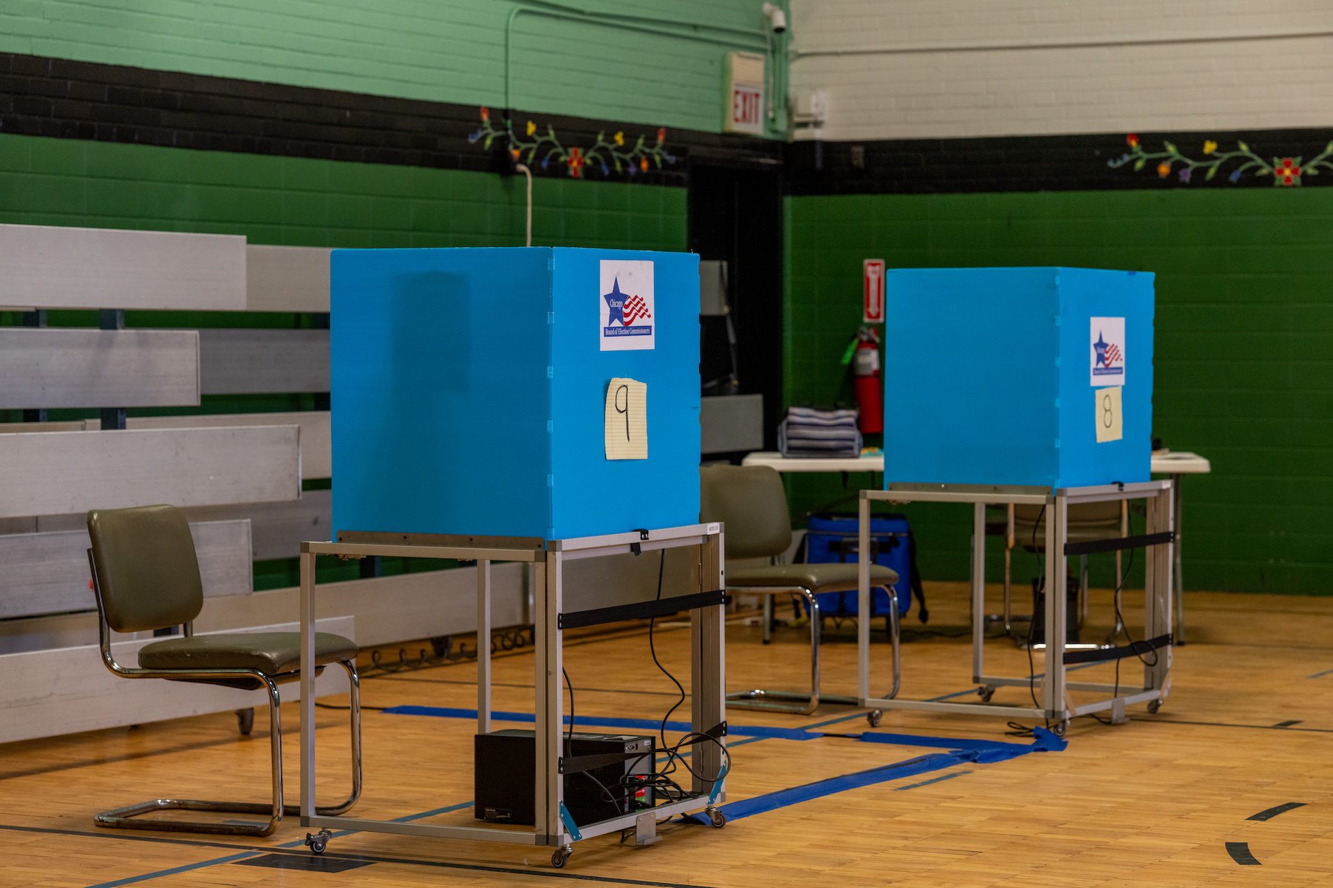 Two voting booths are set up with chairs for early voting at the American Indian Center in Albany Park.