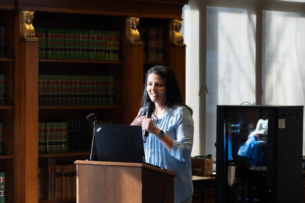 Civil rights attorney Ami Gandhi standing at a podium speaking at an event.