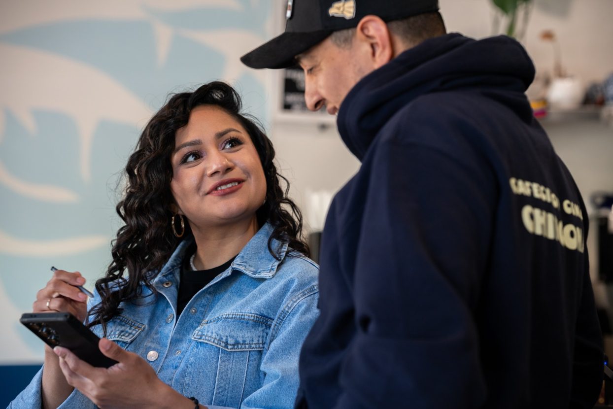 Rocio Villalva looks at Omar Contreras while reviewing a video with Omar Contreras at Dulce De Leech Cafecito in Roscoe Village on Monday, May 11, 2026.