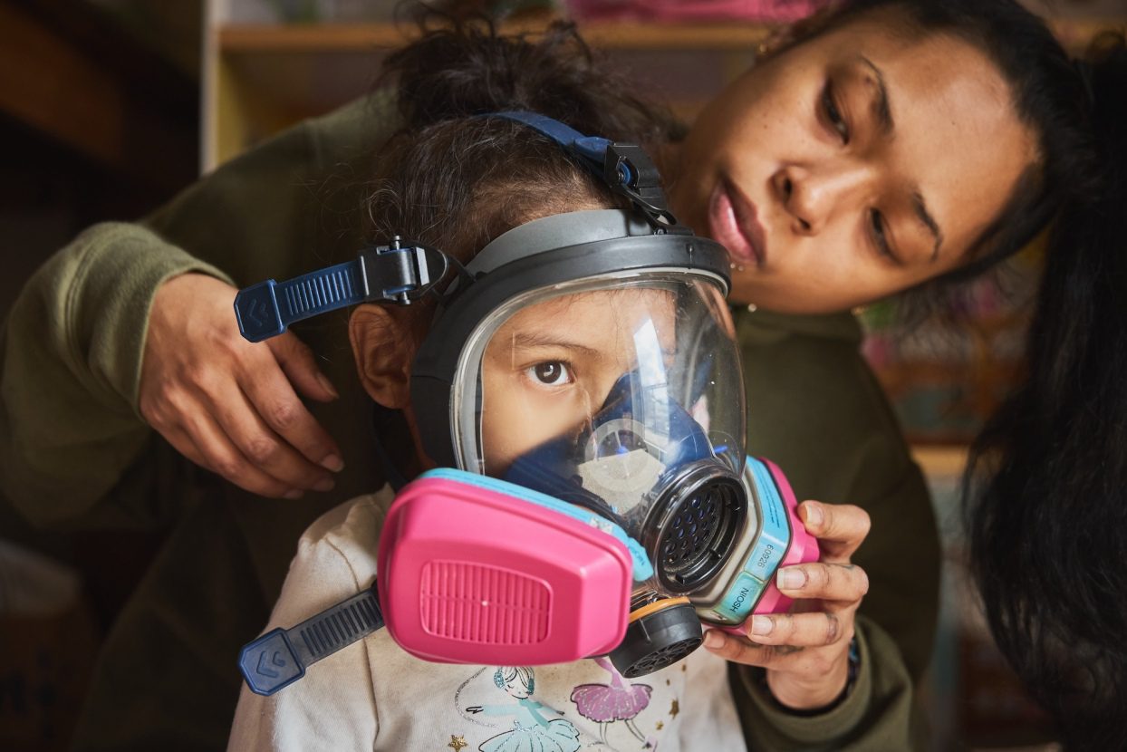 Mindan Ocon puts a gas mask on her daughter, Angelise Ocon, 3, at their family home in Portland, Oregon, on March 9. Protests at the Immigration and Customs Enforcement facility have turned the street outside Ocon’s affordable housing complex into a battlefield of stinging smoke and pepper spray. Ocon has relied on air purifiers and taking her daughter into the bathroom to hide from tear gas, and she’s prepared to use gas masks given to her by community members if it gets worse.