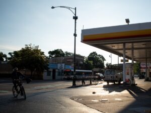 A day laborer arrives on a bike at a gas station early one morning in the Avondale neighborhood.