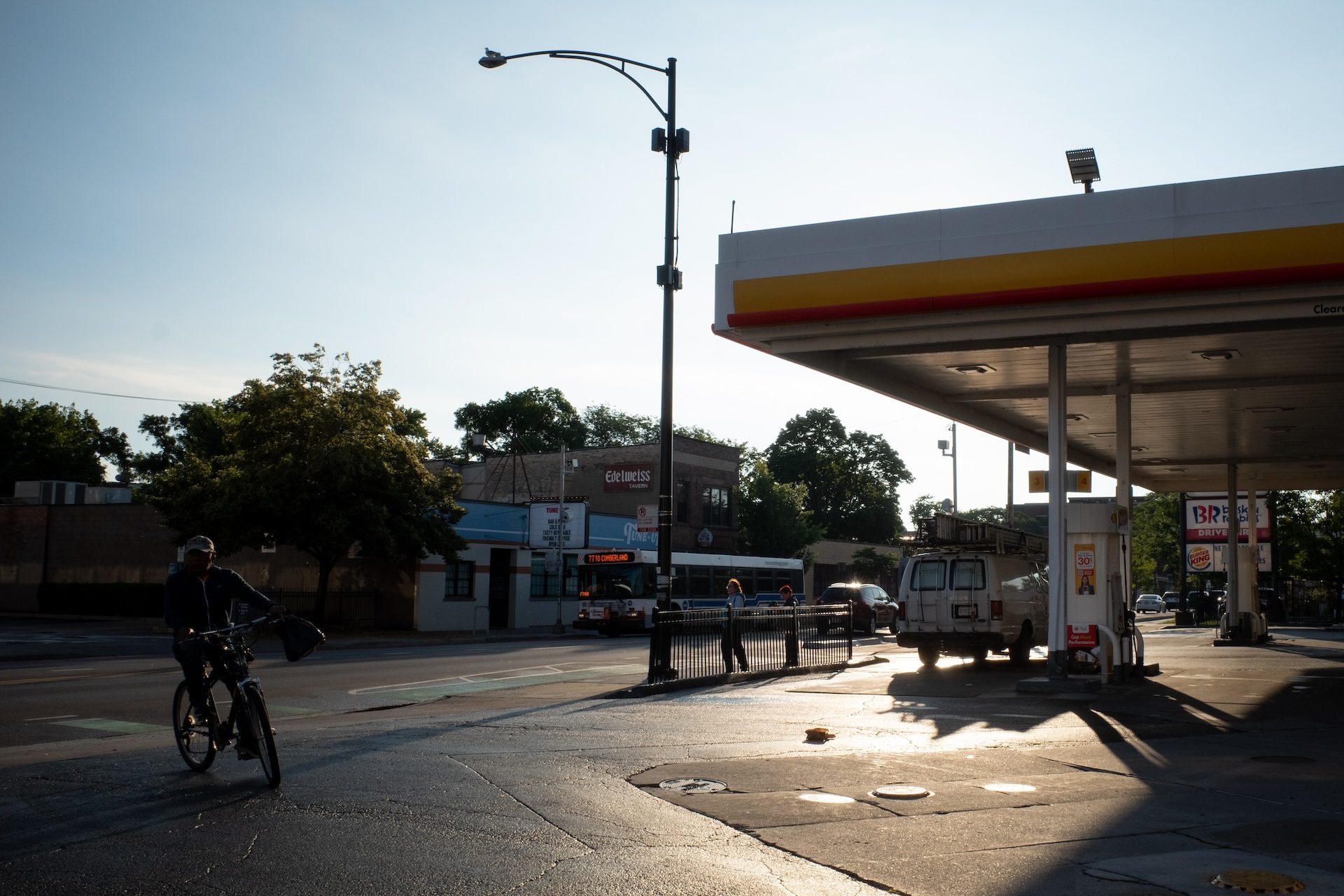 A day laborer arrives on a bike at a gas station early one morning in the Avondale neighborhood.