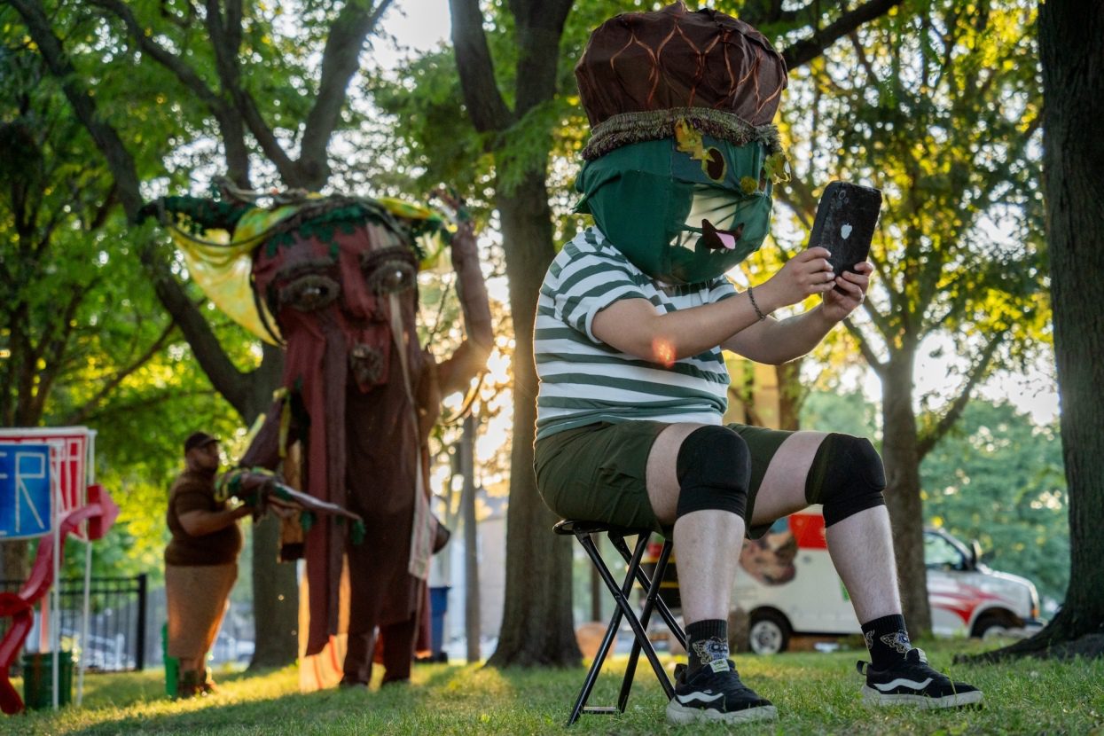 Actor Dre Meza plays an acorn character with a large mask during Free Street's debut performance of "Touch Grass" at Davis Square Park in the Back of the Yards neighborhood.