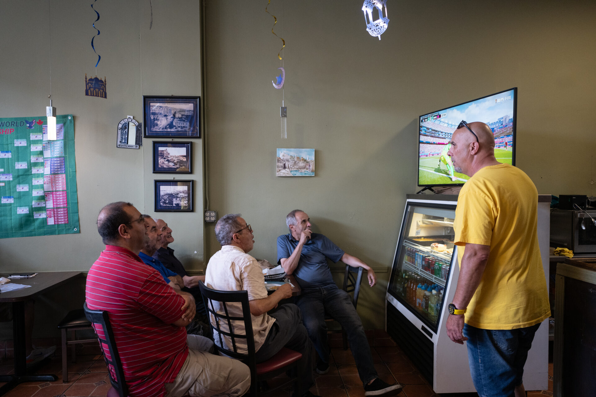 Staff and a group of five customers seated at Algerian and Moroccan restaurant Zebda watch a quarterfinal World Cup match.
