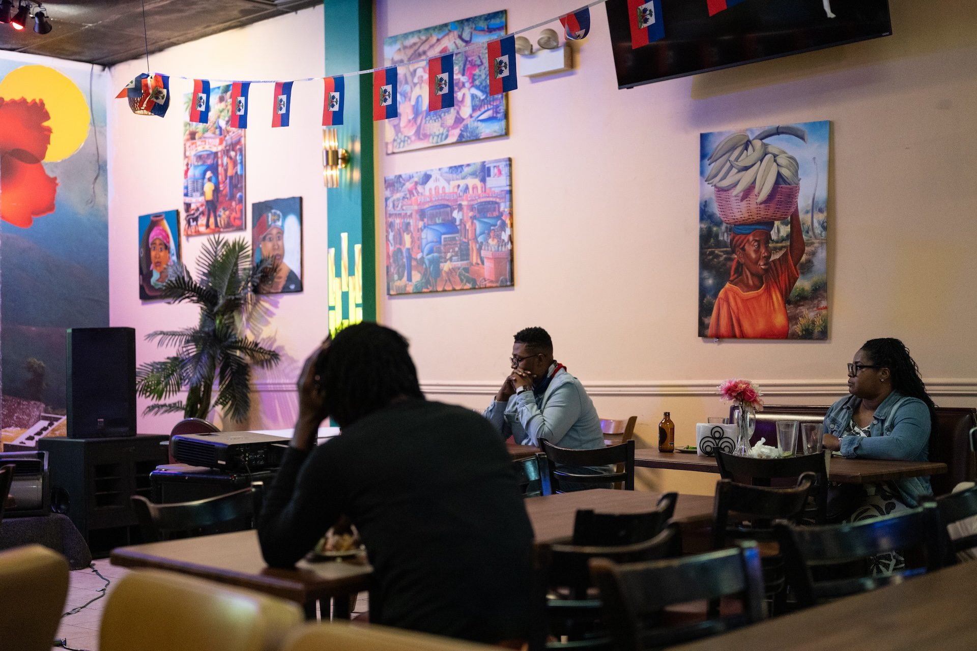 Fans look down and hold their faces as the Haitian team loses 4-2 to Morocco at the Kinzin Creole restaurant in West Ridge.