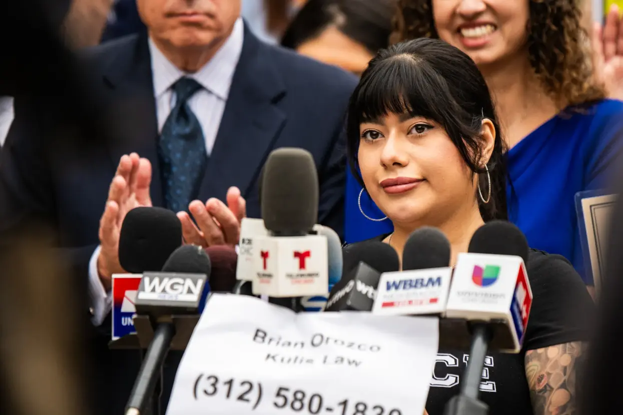 Dayanne Figueroa speaks as elected officials, attorneys, community leaders, and victims from Operation Midway Blitz hold a press conference on Aug. 10, 2026 outside the Chicago Police Department at 2452 W. Belmont Ave. in North Center ahead of filing police reports with the Chicago Police Department that allege crimes committed by ICE agents.