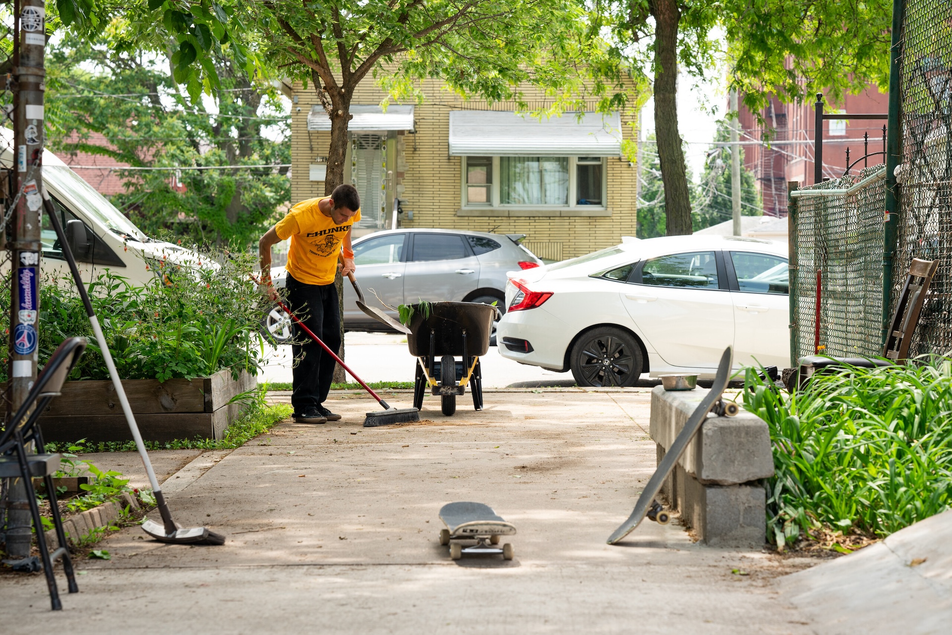 Adlai Abselrazaq cleans up the community garden area at Marshfield Courts on June 7, 2026.