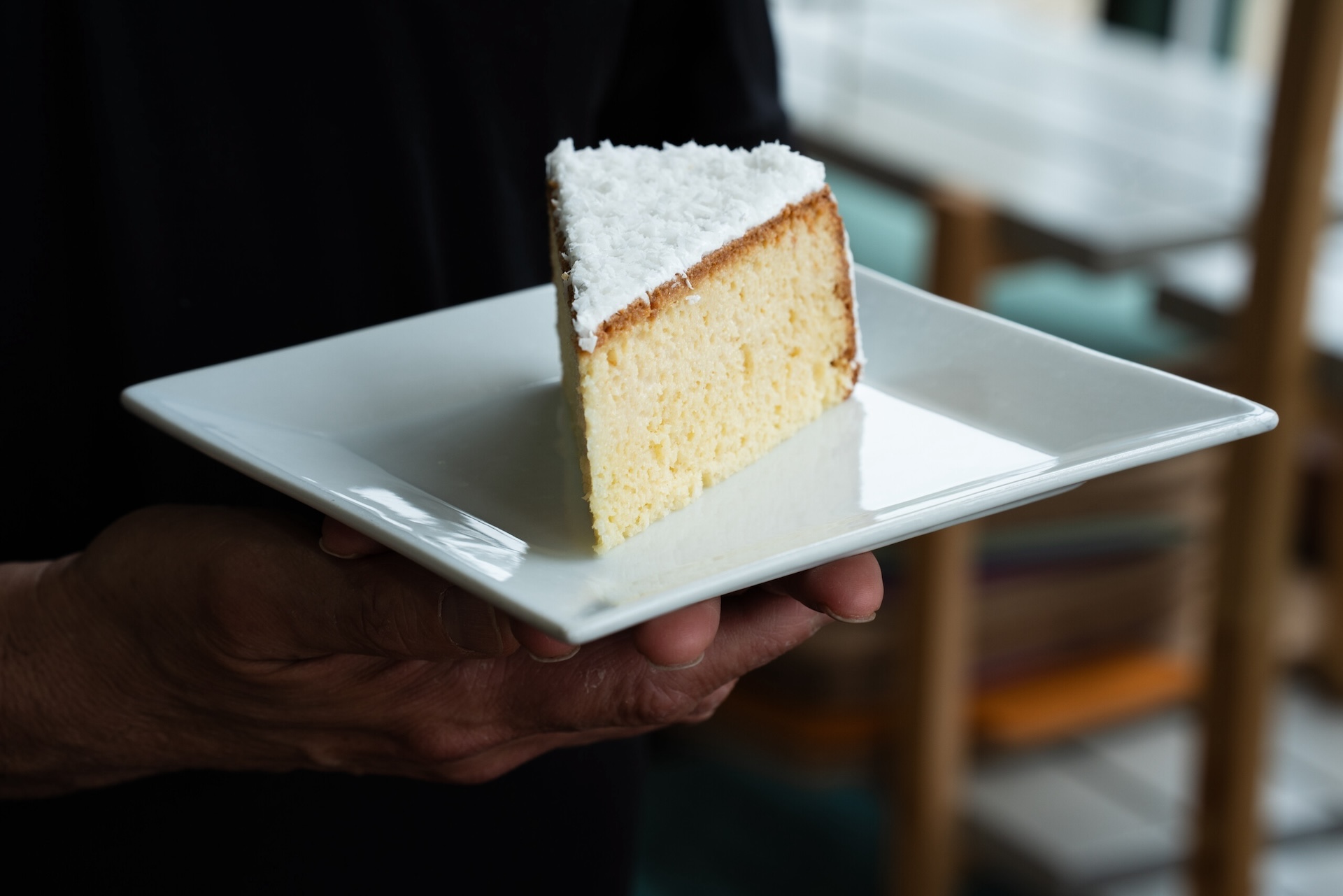 A slice of tres leches cake sits on a white plate at Kristoffer’s Cakes bakery.