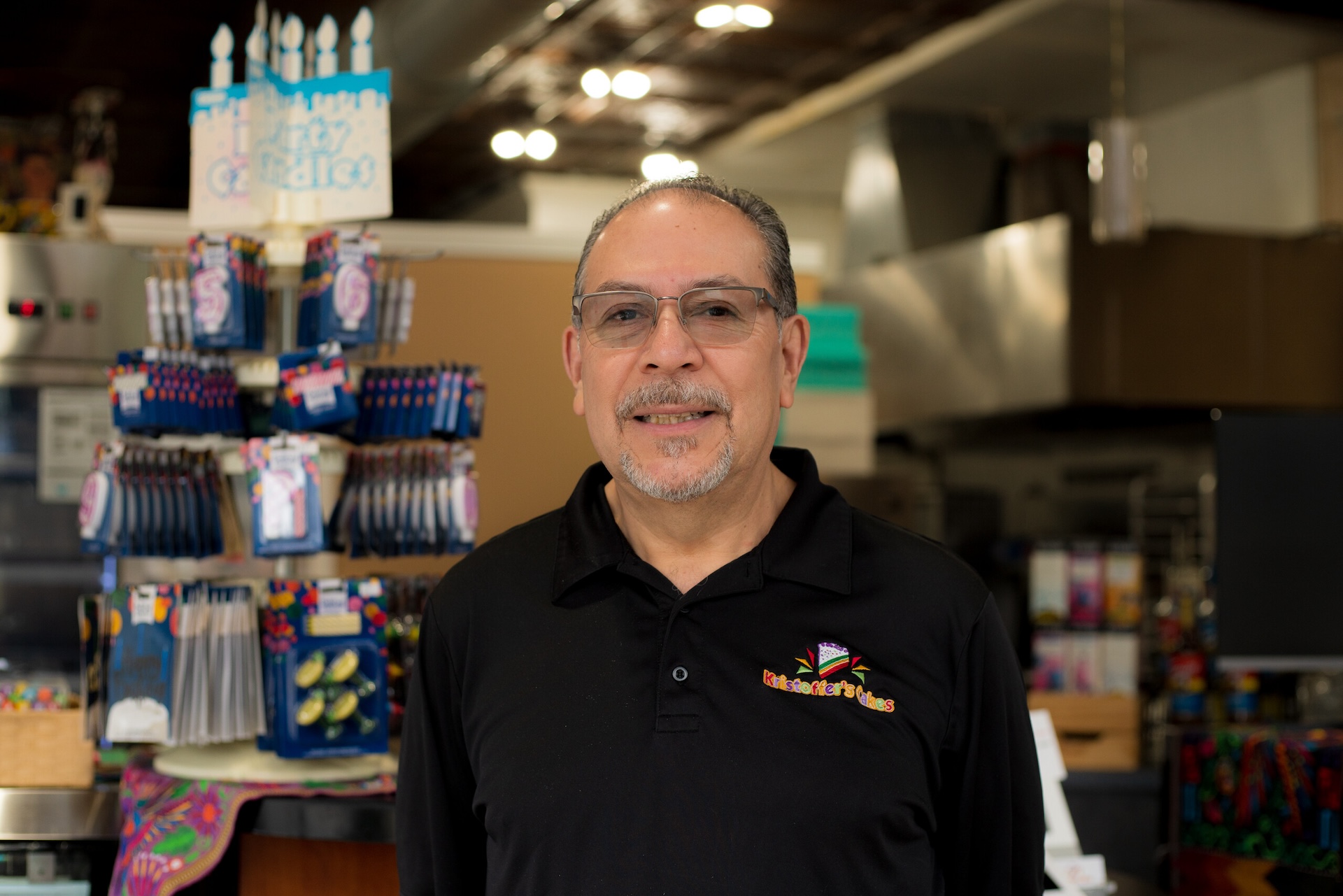 Co-owner Carlos Chavarria wears a polo shirt with the logo of his restaurant, Kristoffer's Cakes bakery.