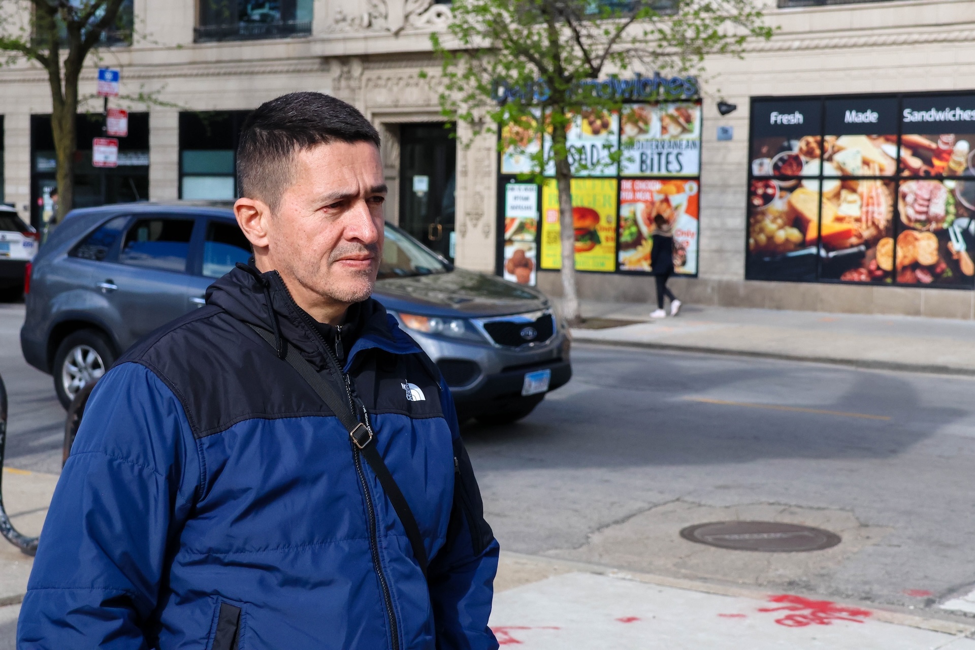 Pabon, a Venezuelan farmer, who came to the U.S. four years ago stands outside on a city street.