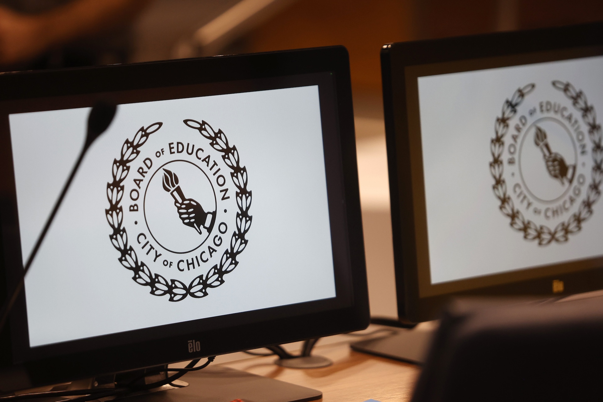 A close-up view of computer screens with Board of Education logo screen savers.
