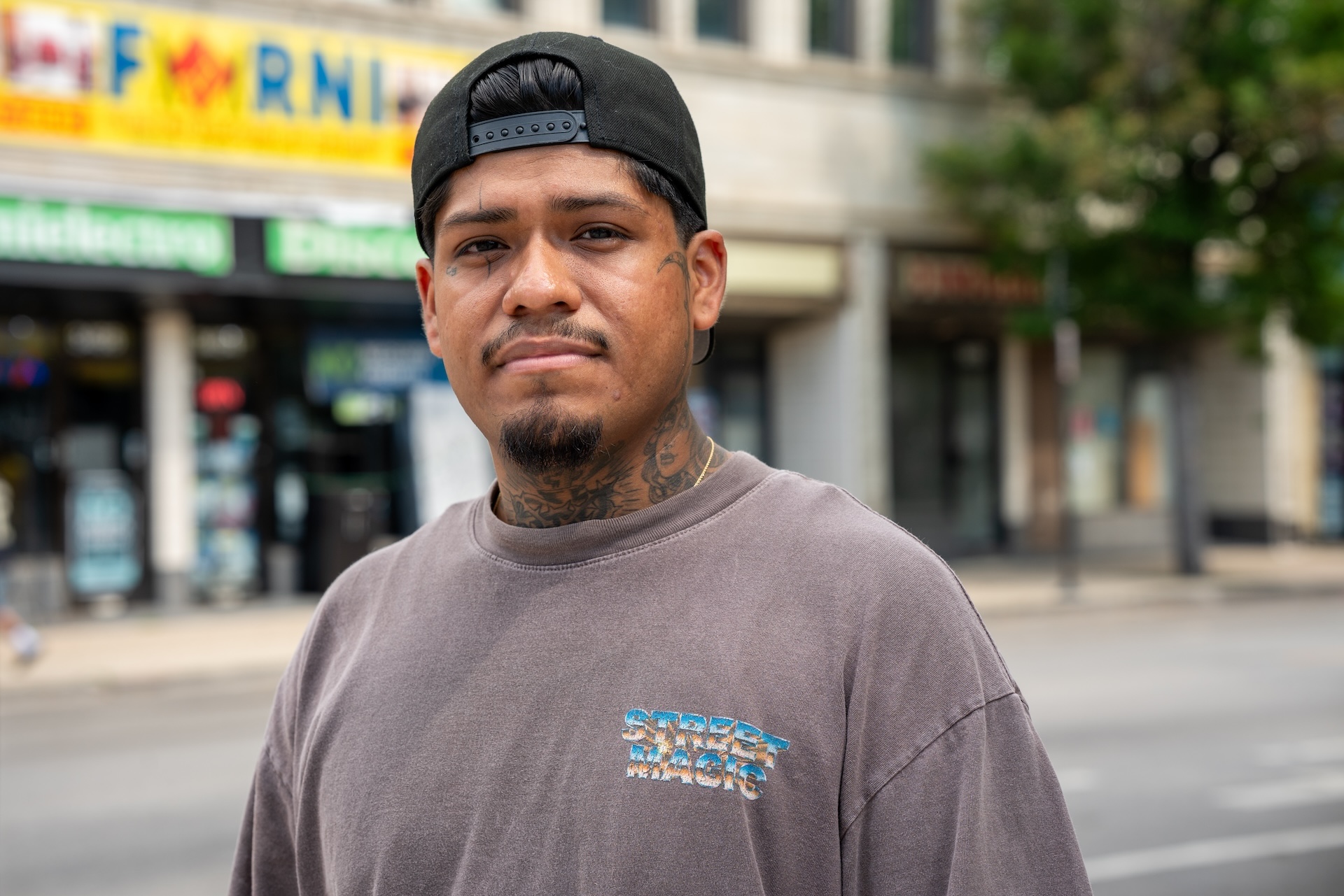 Brian Nazario, stands on Lawrence avenue, in the neighborhood where he grew up, Albany Park.