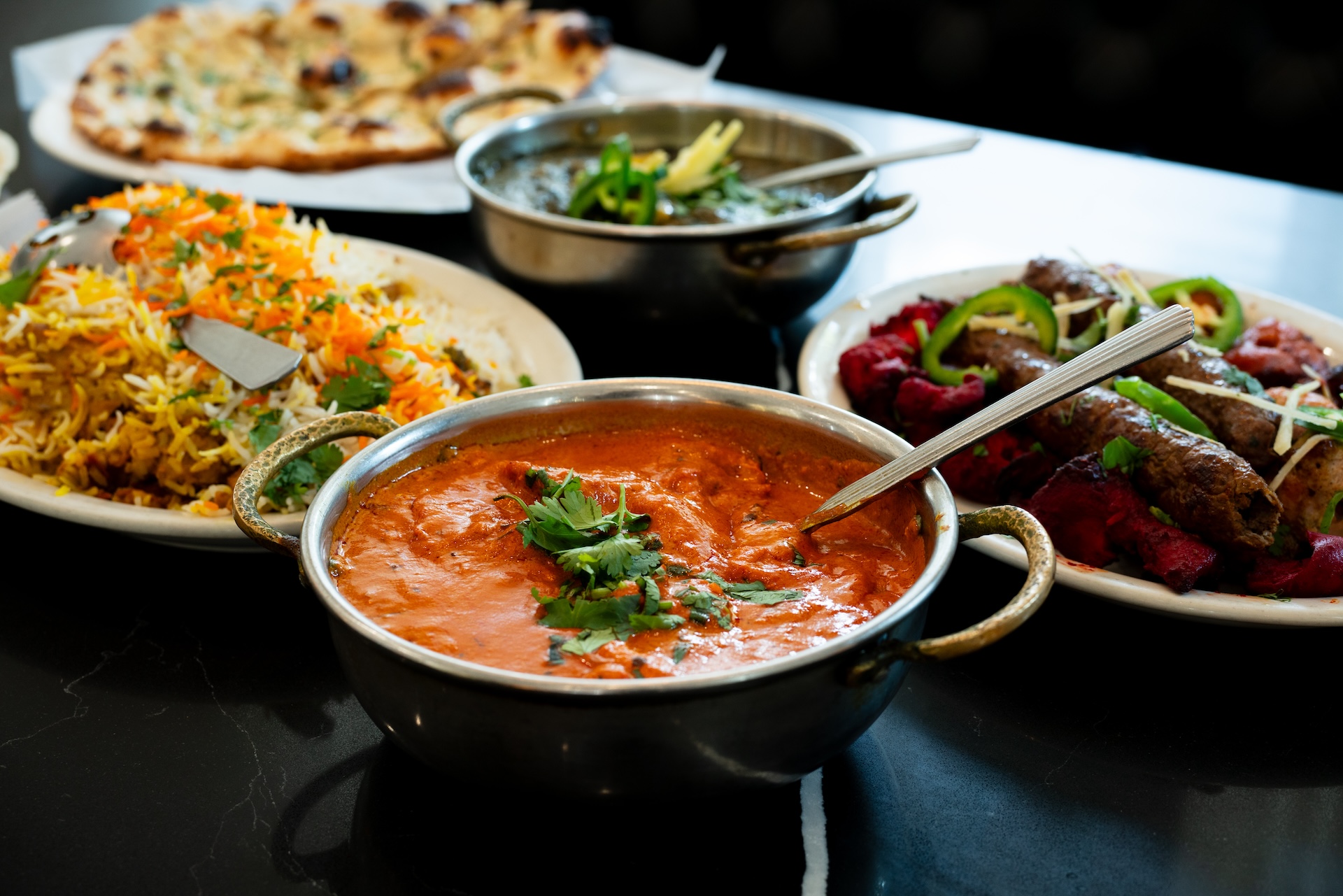 A close up of multiple dishes at Sabri Nihiri, a family owned Pakistani restaurant.