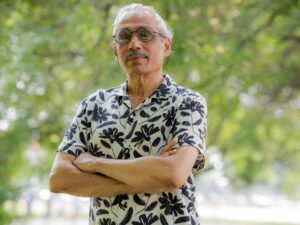 Community organizer Baraht Sharma stands for a portrait with his arms crossed in West Ridge’s Warren Park.