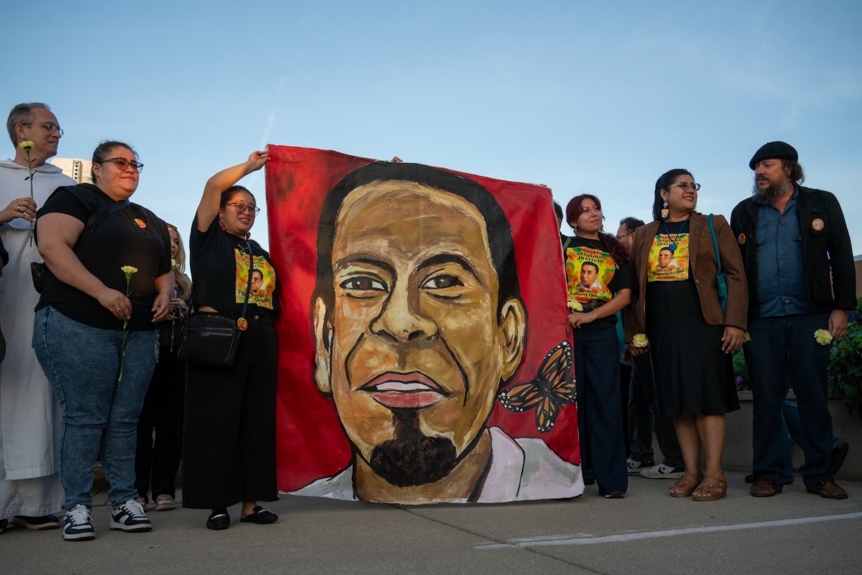 Organizers with Hijas del Pueblo, Casa Du Page and the Resurrection Project hold up a large painted portrait of Silverio Villegas González on canvas outside the Franklin Park Police Department at 9451 W. Belmont Ave. on Aug. 17, 2026.