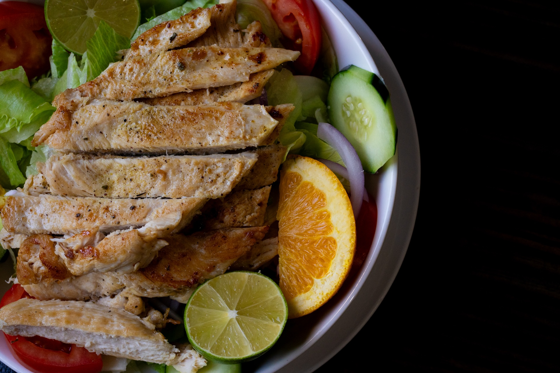 A chicken salad, garnished with a lime and orange at La Fogata restaurant.
