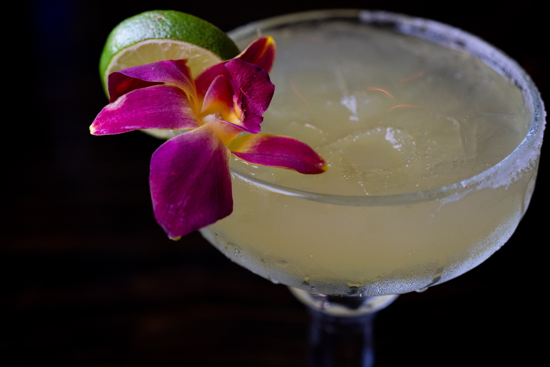 A margaraita garnished with a lime wedge and small flower at La Fogota's restaurant.