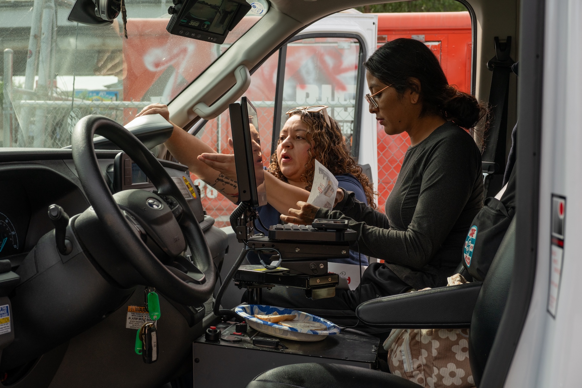Dr. Melissa Argüelles (left) and EMT Marta Green (right) look over paperwork inside the CARE (Crisis Assistance Response and Engagement) van before heading out for a shift on Sept. 14, 2026.