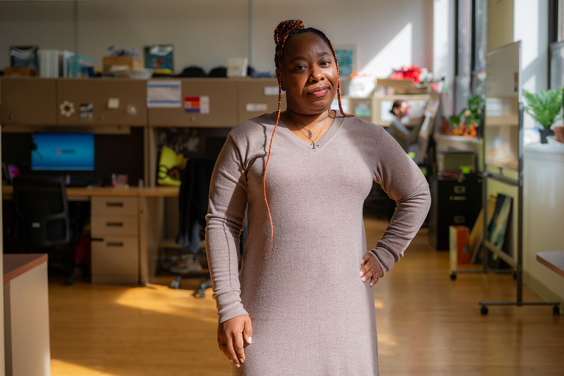 Window light reaches Tiffany Patton-Burnside as she stands for a portrait inside the CDPH offices.