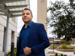 Mustafa Rfat stands for a photo on the campus of the University of Nebraska at Omaha’s Grace Abbott School of Social Work. Rfat is an assistant professor of social work at the university.
