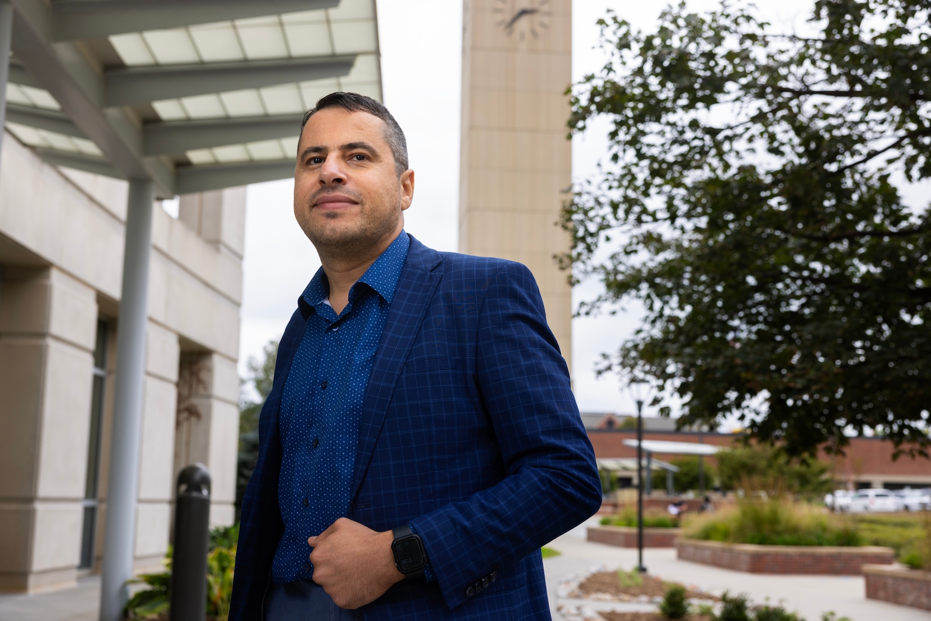 Mustafa Rfat stands for a photo on the campus of the University of Nebraska at Omaha’s Grace Abbott School of Social Work. Rfat is an assistant professor of social work at the university.