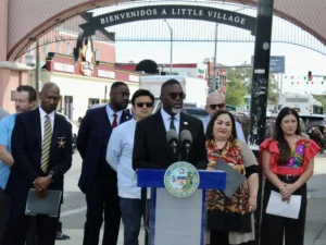 Mayor Brandon Johnson stands alongside elected officials and organizers under the Little Village Arch to discuss plans for the upcoming Mexican Independence Day celebrations this weekend.