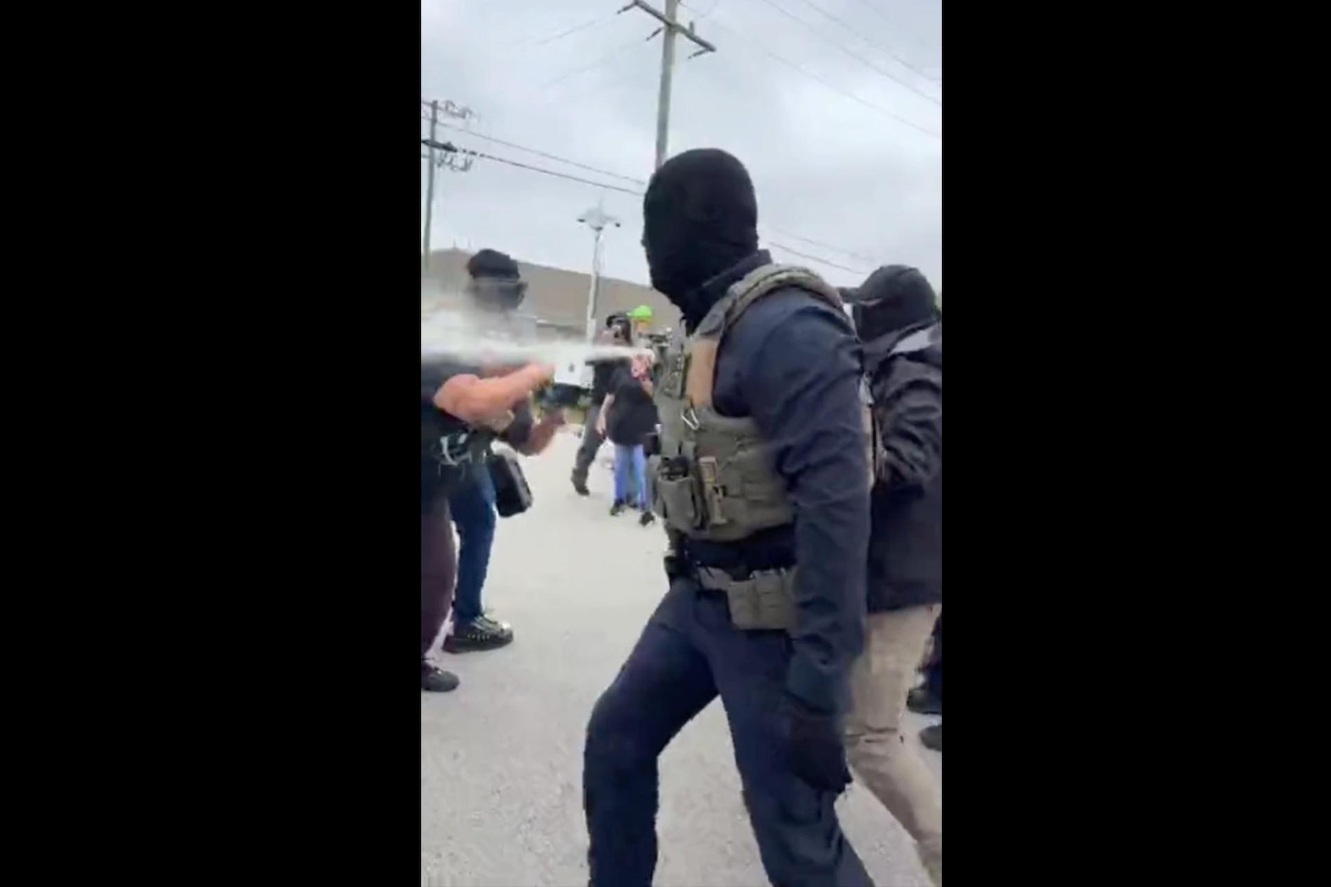 Federal agents wearing masks use pepper spray on protesters outside the Broadview immigration processing facility on Sept. 19, 2026.
