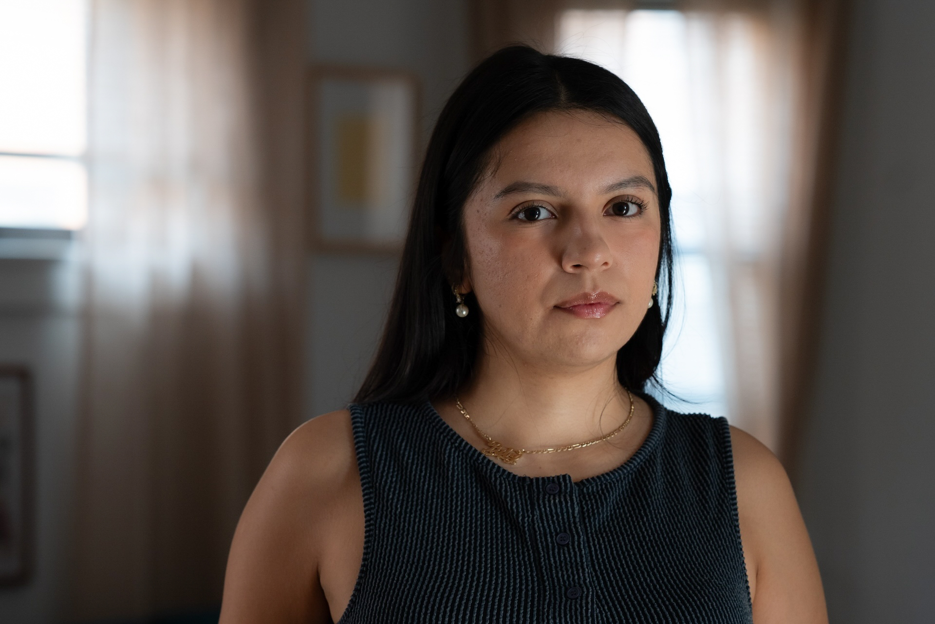Olga Guerrero Gonzalez looks away from the camera at her home office.